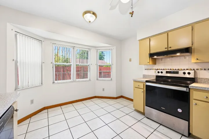 A CHARMING BAY WINDOW BREAKFAST NOOK is filled with natural light and peaceful backyard views.