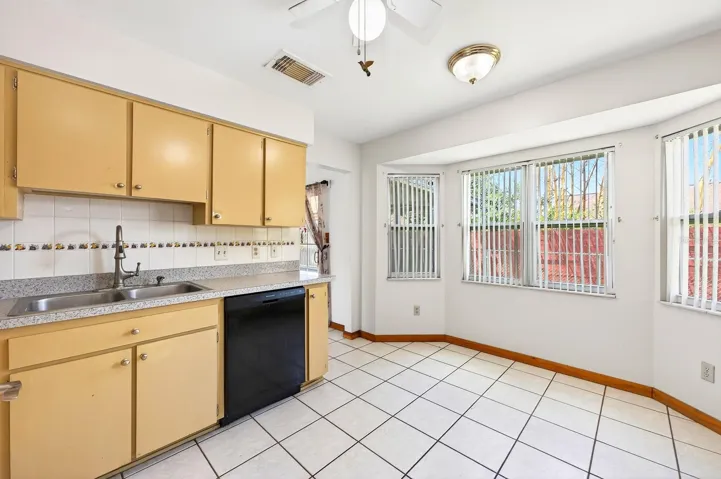 A CHARMING BAY WINDOW BREAKFAST NOOK is filled with natural light and peaceful backyard views.