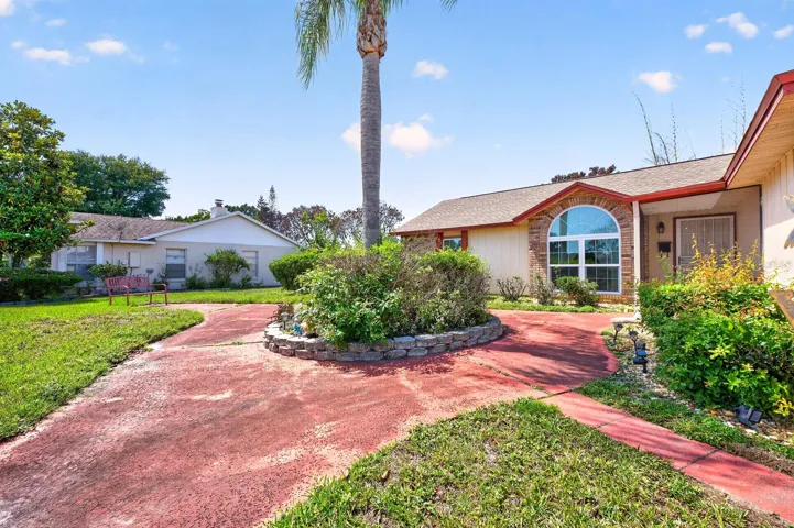 From the moment you arrive, the home stands out with its beautiful architectural details, including a striking ARCHED FRONT WINDOW with brick facing.