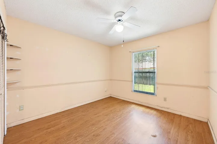 On the opposite side of the home, two additional bedrooms with LAMINATE FLOORING share a SECOND FULL BATH, offering flexibility for guests, family, or a home office. Bedroom 3
