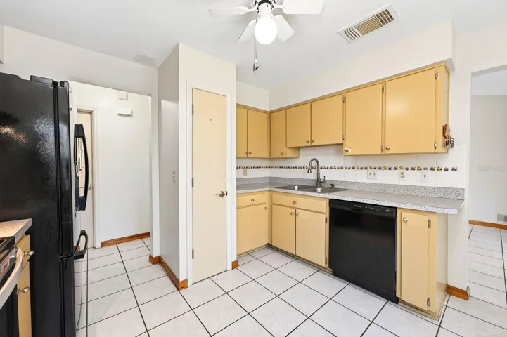 The Kitchen offers abundant solid wood cabinetry, ample counter space and a tile backsplash.