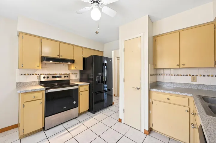 The Kitchen offers abundant solid wood cabinetry, ample counter space and a tile backsplash.