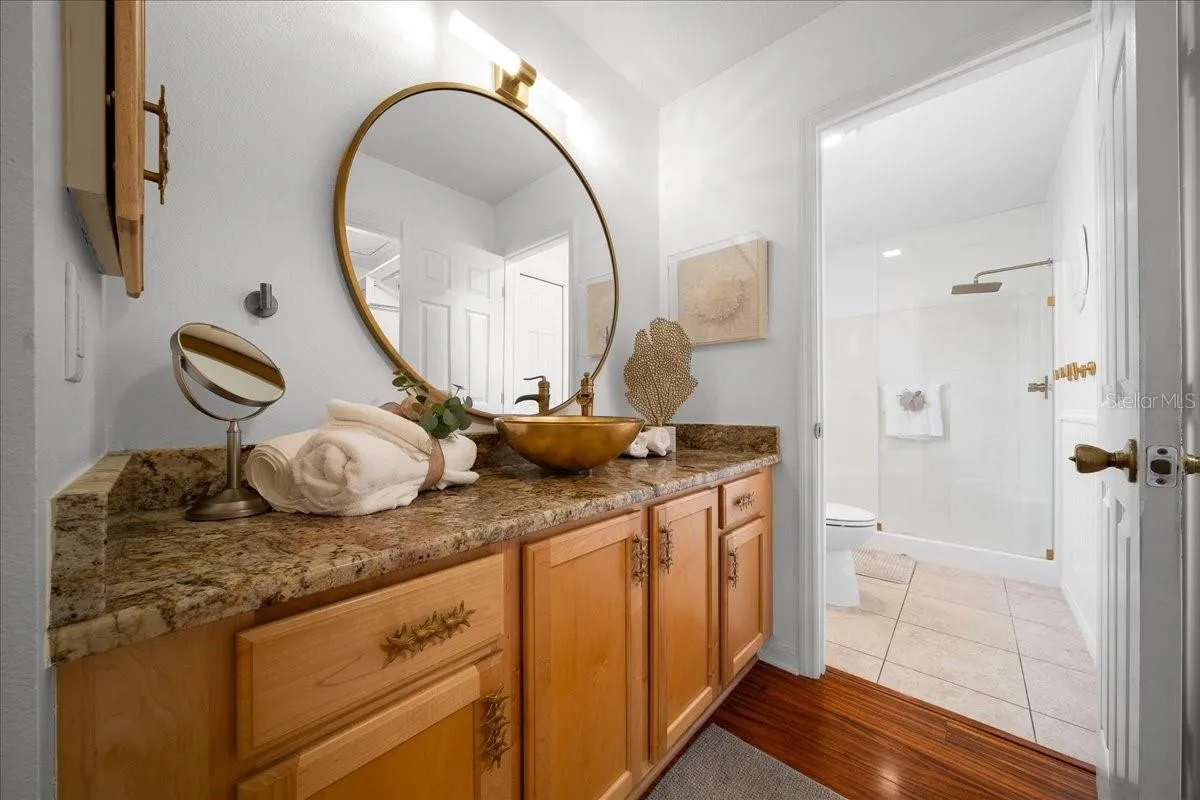 Primary Bathroom Features Updated Mirror, Faucet, and Handles