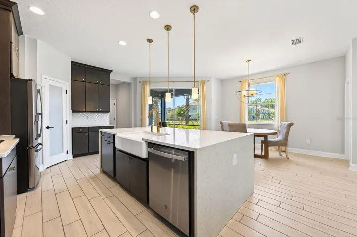 Kitchen is open to the living and dining areas with sliding glass doors that open to the screened lanai.