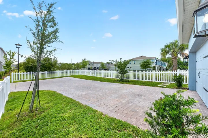 2-car garage, extended L shaped paver driveway.