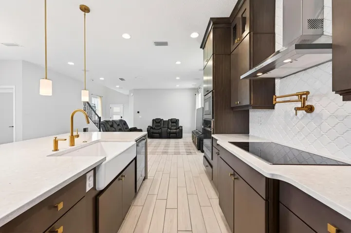 Rich cabinetry is paired with a waterfall island and chic hardware.