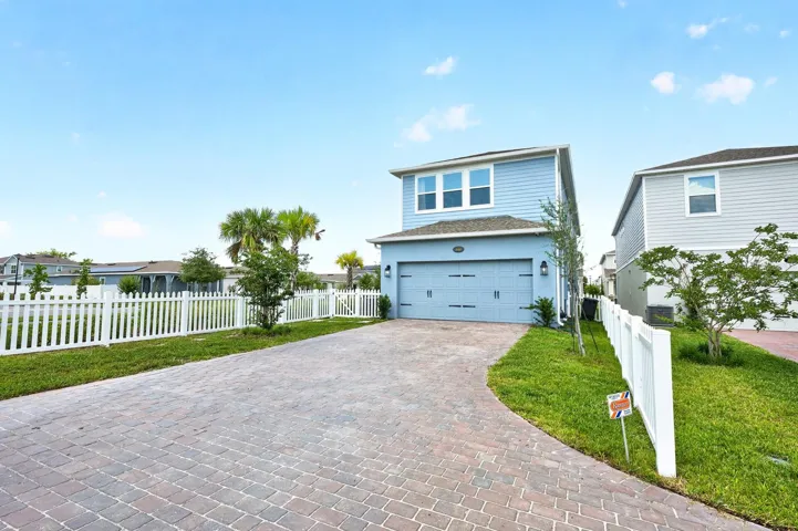2-car garage, extended L shaped paver driveway.