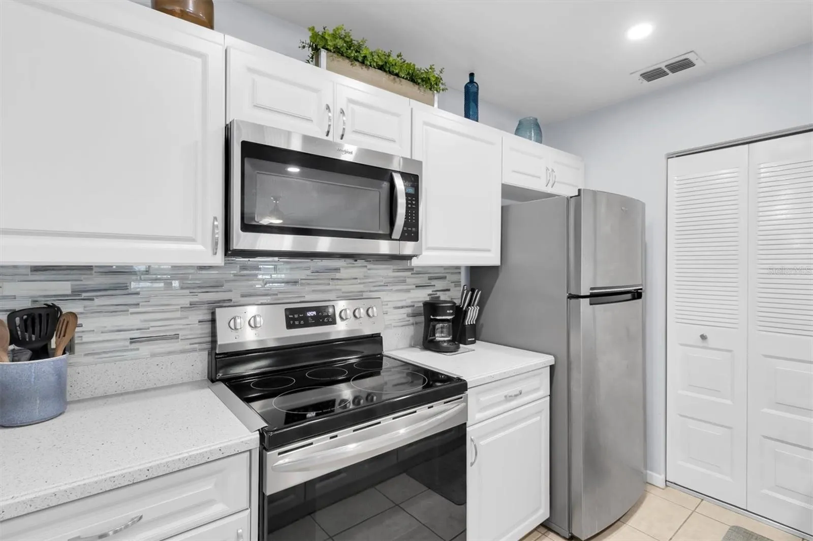 Galley Kitchen with stainless steel appliances