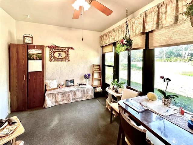 Exit from 4 season/screened in porch looking over back garden view.