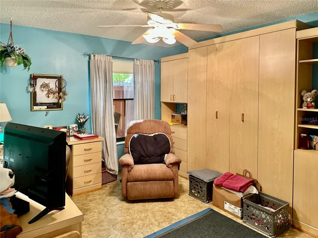 Guest bedroom/office with built in murphy bed and built in desk.