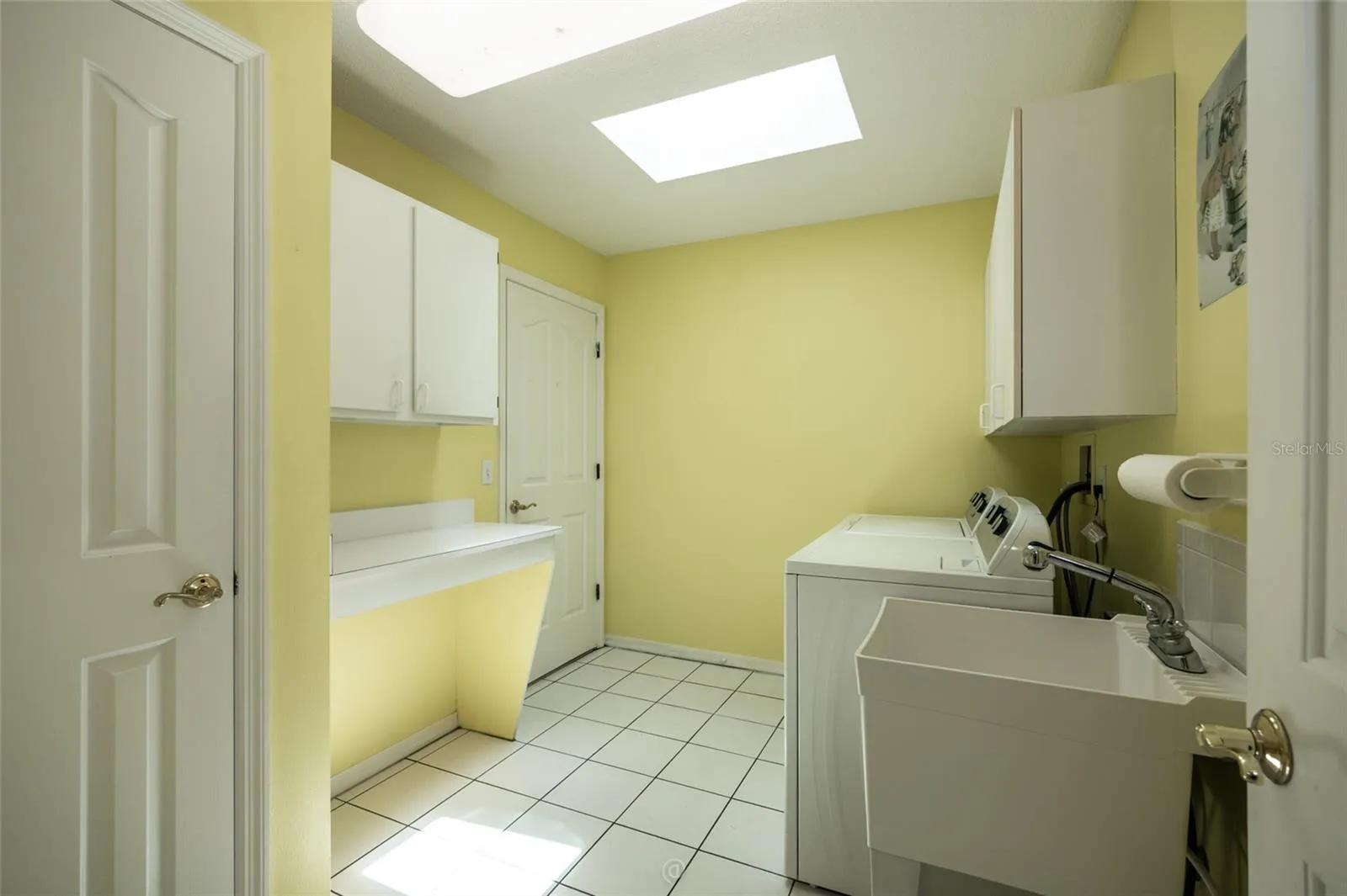 Laundry room with loads of storage