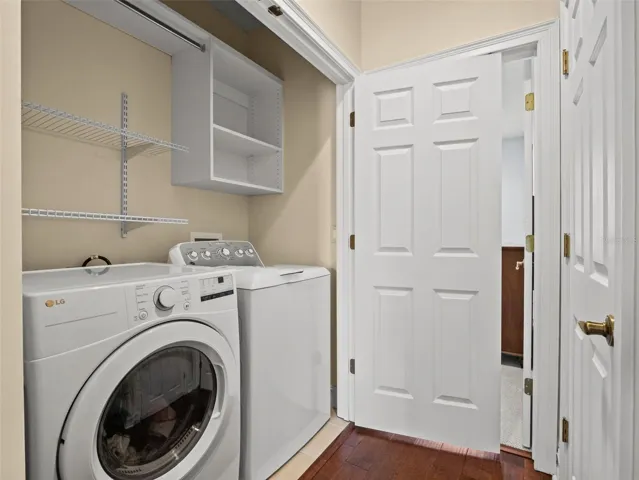 Upstairs laundry closet with storage.