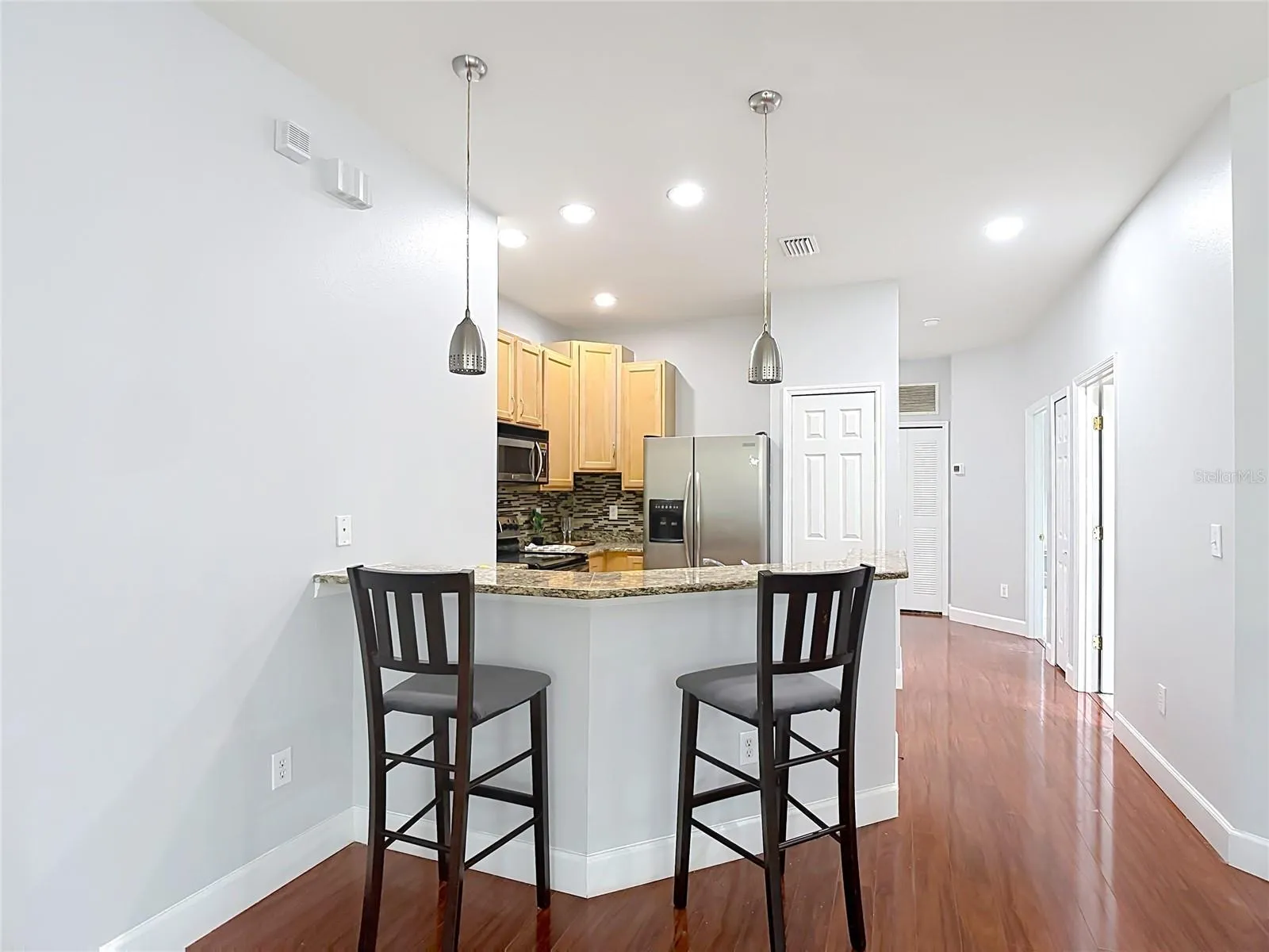 9502 W Park Village 108 Dining area view toward kitchen and breakfast bar