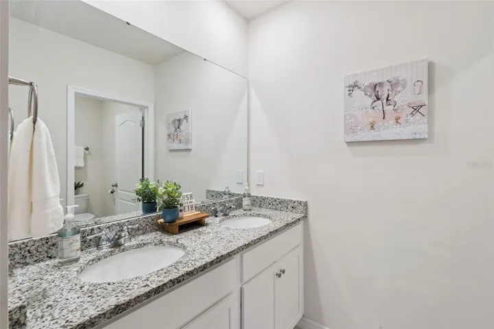 The third bathroom complete with linen closet and dual sinks is found between bedrooms 4 and 5