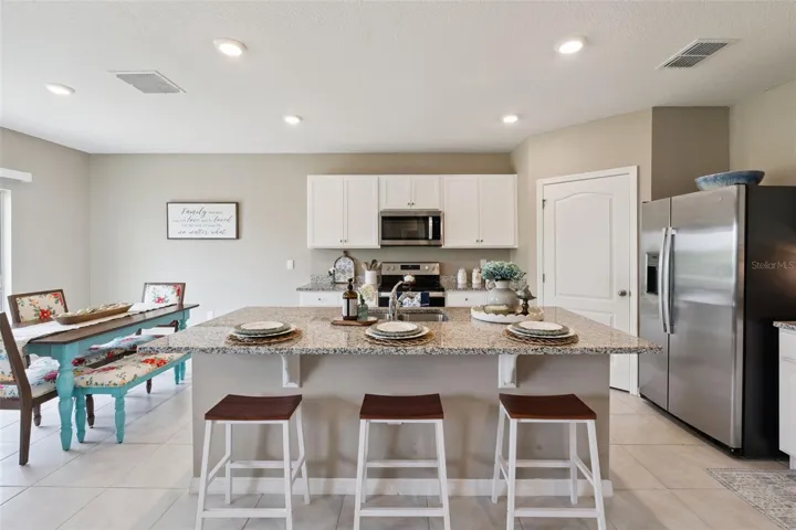 Kitchen has a nice size island, plenty of counter space and pantry to the back right