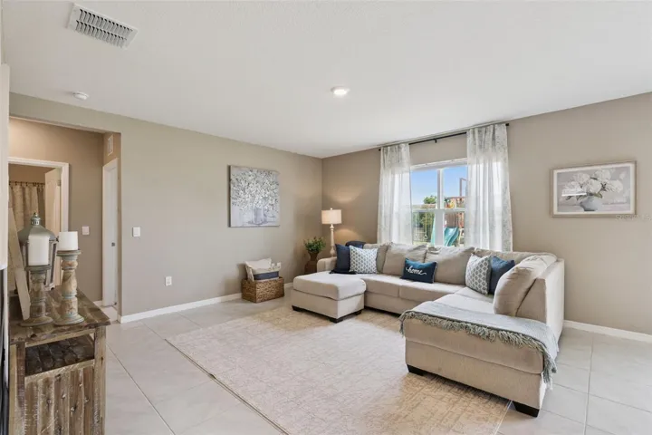 At the back of the house to the left of the foyer is a nice size family room which overlooks the backyard