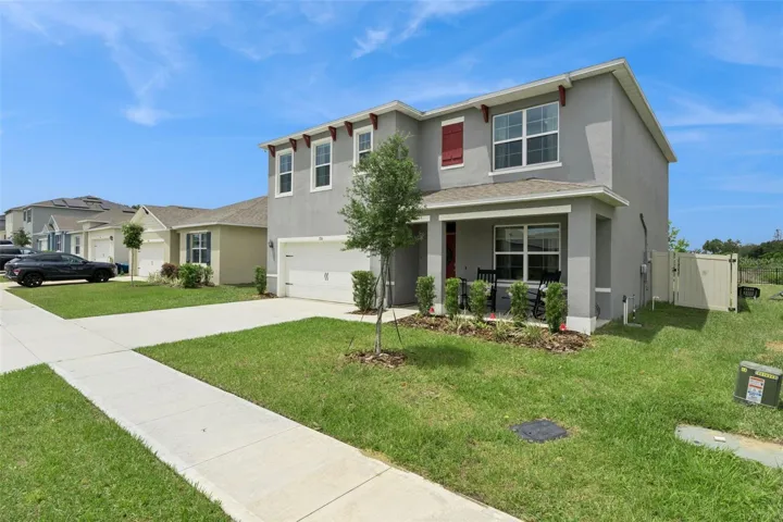 A two car garage and ample driveway complete the front elevation