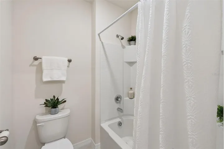 Bathroom three also offers a tub shower combination