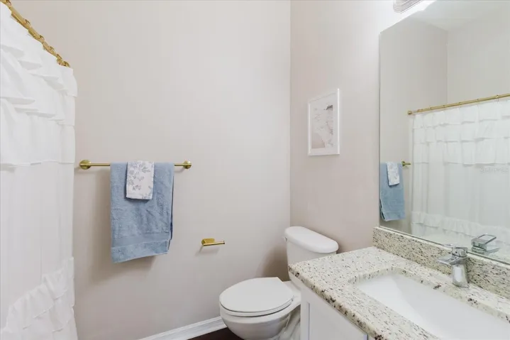 2nd Upstairs Bath With A Single Granite Counter Vanity, Luxury Vinyl Floors, &amp; A Tub/Shower Combo