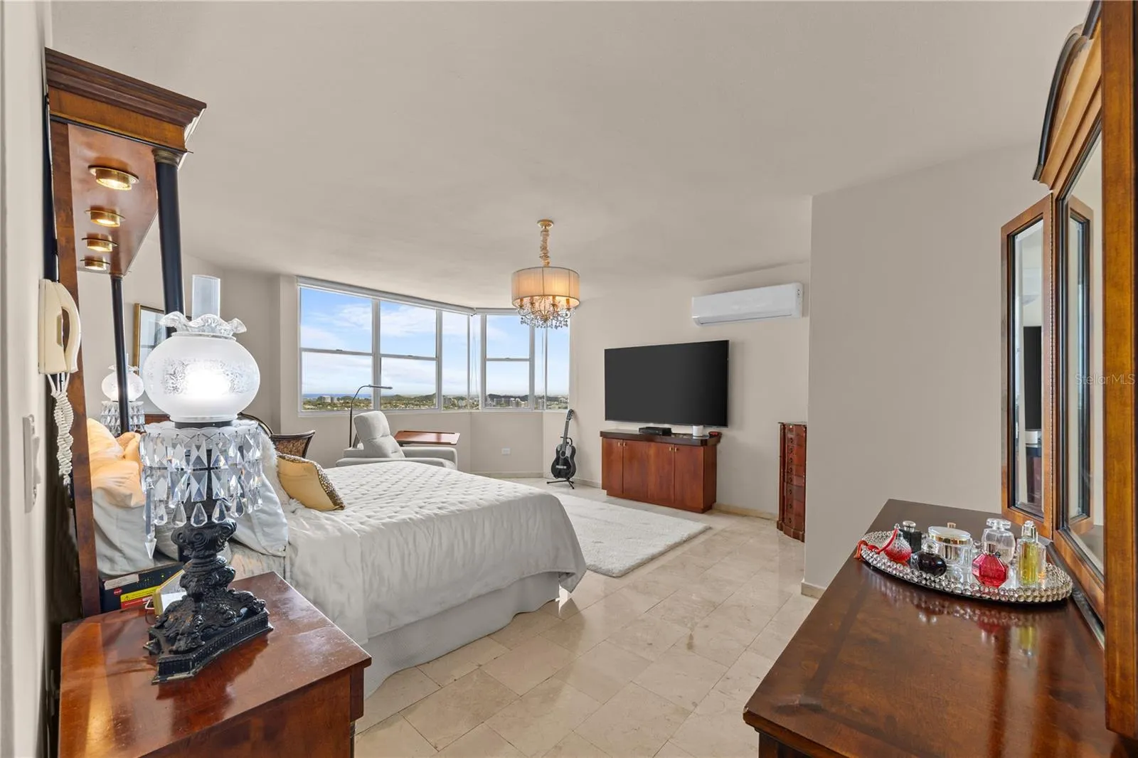 The primary bedroom is incredibly spacious and filled with natural light, with stunning views that create a peaceful and luxurious atmosphere from the moment you wake up