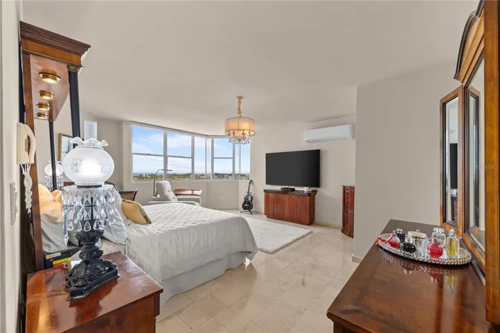 The primary bedroom is incredibly spacious and filled with natural light, with stunning views that create a peaceful and luxurious atmosphere from the moment you wake up