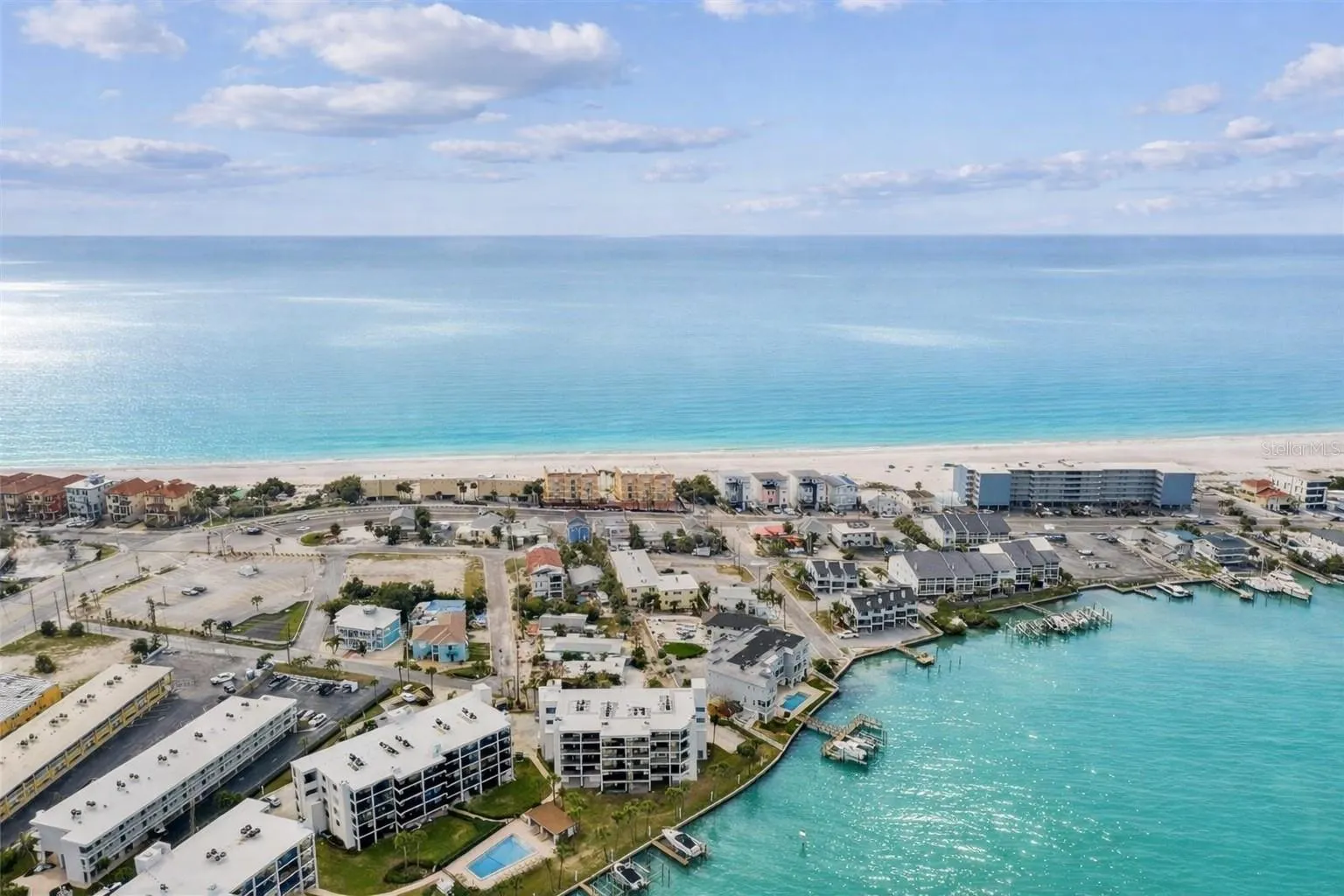 BEST LOCATION ON TREASURE ISLAND!  Between the Gulf of Mexico and Blind Pass Waterway, Unit 404 offers the perfect blend of waterfront living and beachside convenience.