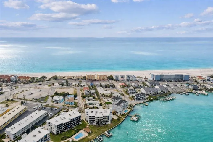 BEST LOCATION ON TREASURE ISLAND!  Between the Gulf of Mexico and Blind Pass Waterway, Unit 404 offers the perfect blend of waterfront living and beachside convenience.