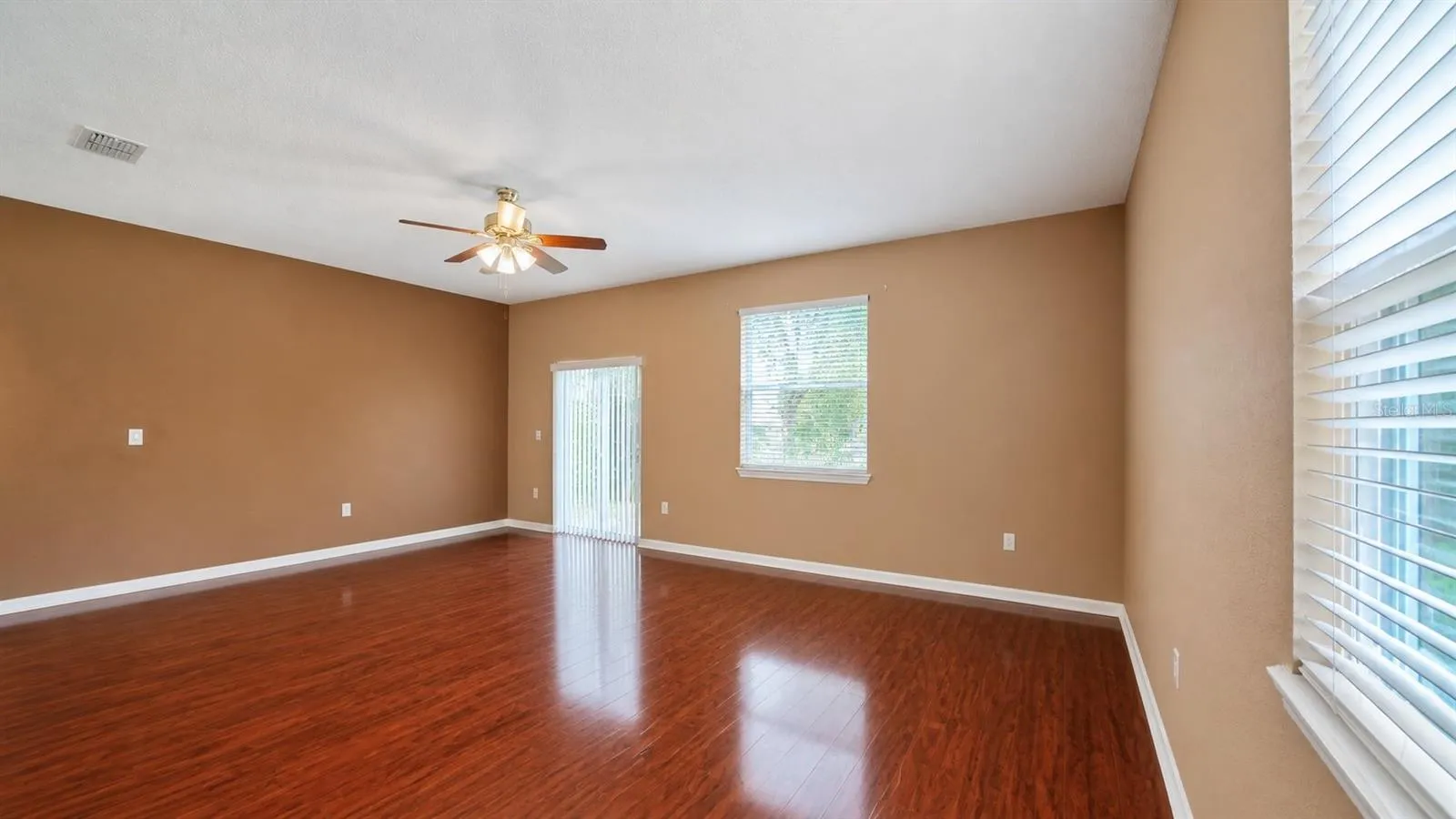Living room is adjacent to the entry, kitchen and dining room.