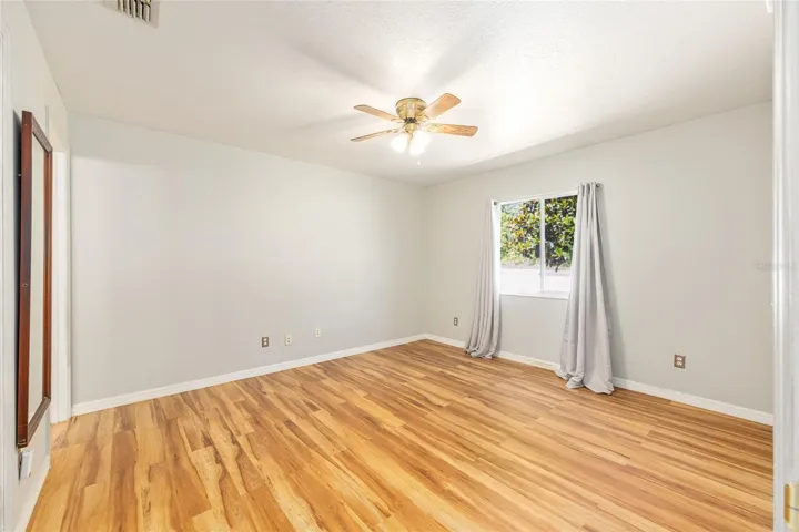Primary Bedroom with Window and Ceiling Fan