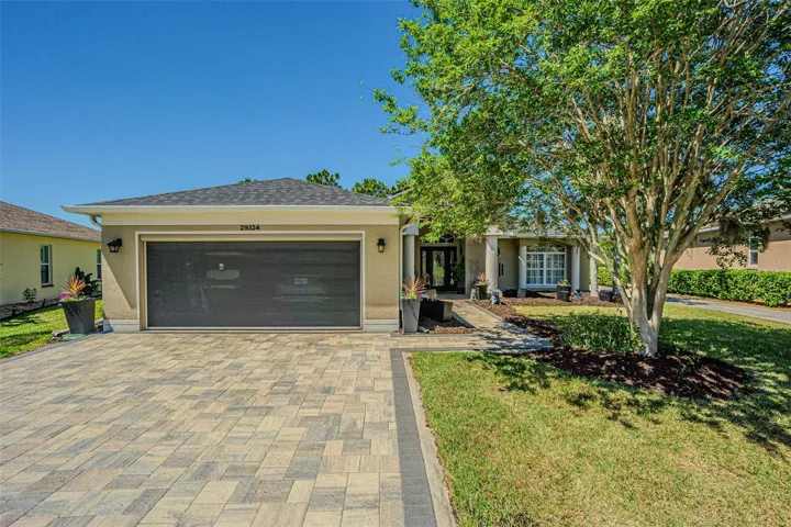 Pavers and an electric roll-down garage door screen.