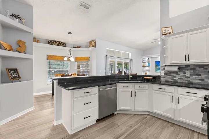 Upgraded kitchen, opening to the dinette area and living room.