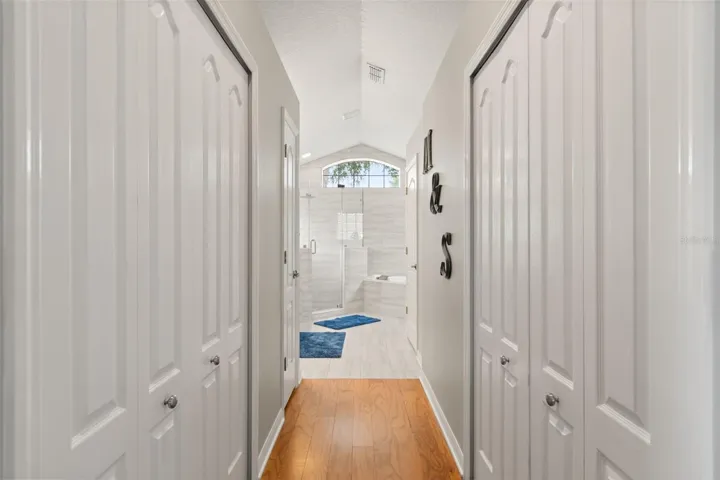 Hallway with 2 walk-in closets, leading to the ensuite bathroom.