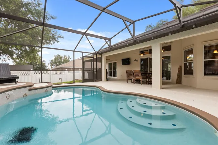 Pool with covered lanai, and screen enclosure.