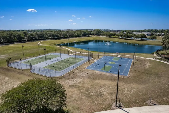 View of tennis and basketball courts at recreational facility.