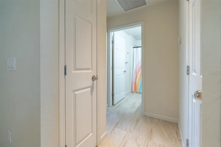 Two hall closets are shelved for storage.