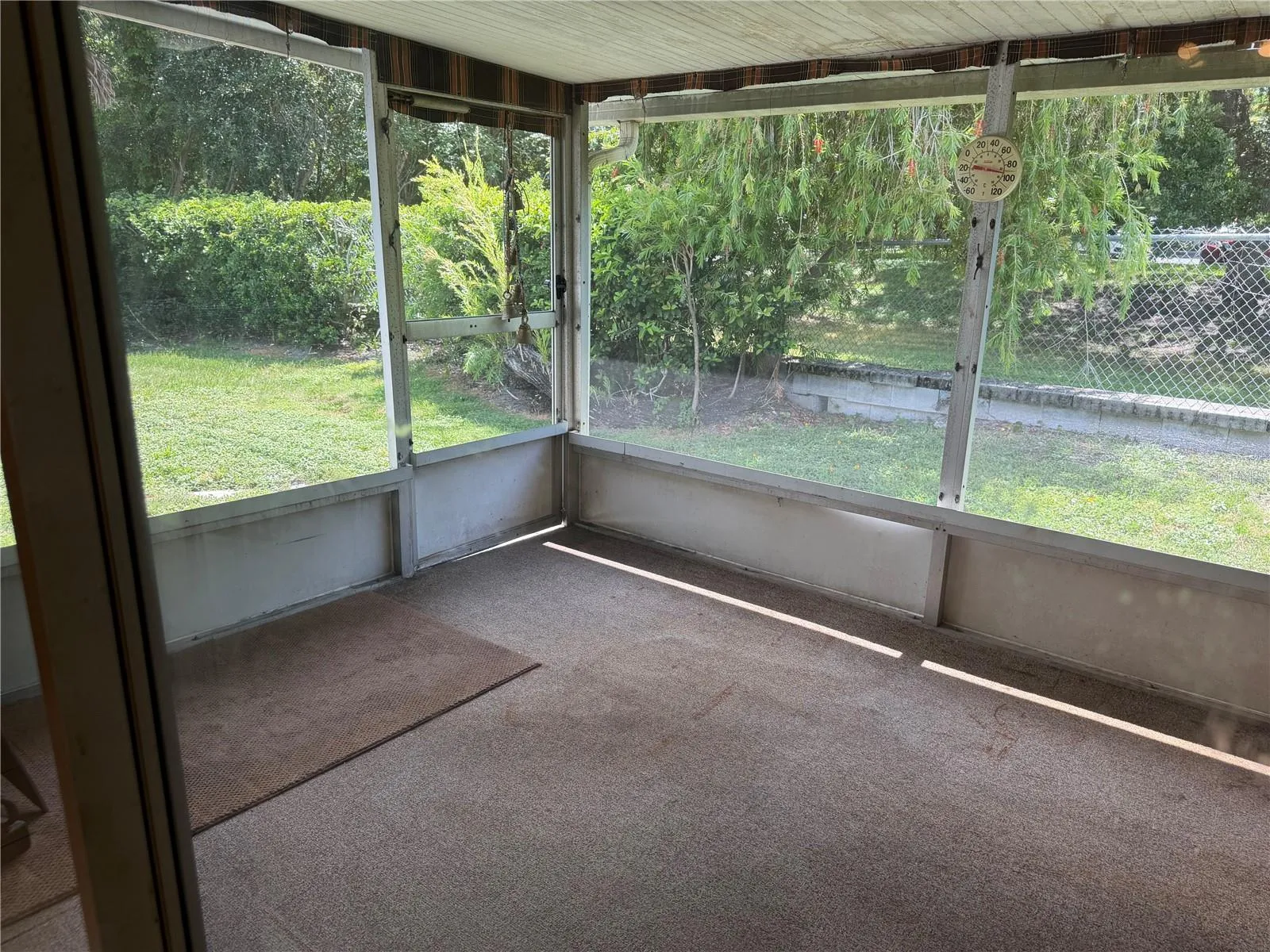 Large Florida Room with sun shades, htat leads out to your private backyard space.