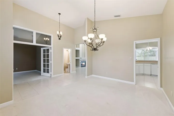 Dining Room with view of foyer, formal living room, and view of family room and kitchen entrances