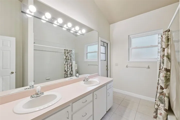 Bathroom 2 with double sinks and pool door