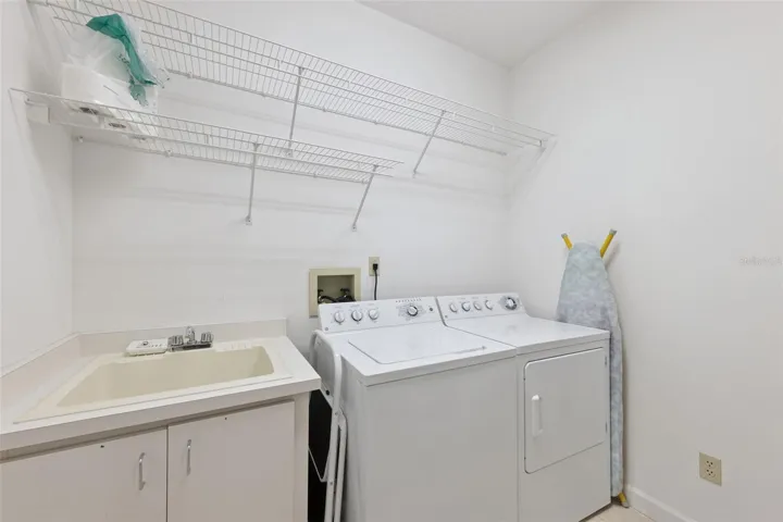 Laundry Room with shelving and closet space