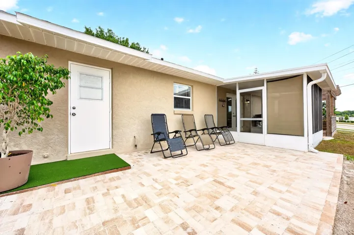 A NEW PAVER PATIO (2026) and an ADDITIONAL PAVER PATIO with DECORATIVE TRELLIS (2025) create charming spaces for outdoor dining, relaxing, or entertaining under the Florida sky.