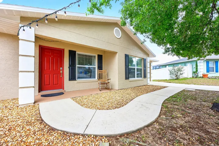 From the moment you arrive, the home welcomes you with a LARGE, LUSH OAK TREE that provides wonderful shade and timeless curb appeal, especially during relaxing Florida evenings.