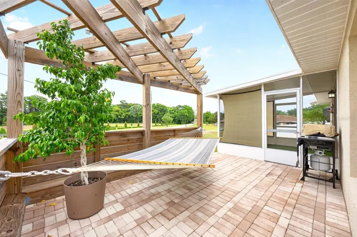 A NEW PAVER PATIO (2026) and an ADDITIONAL PAVER PATIO with DECORATIVE TRELLIS (2025) create charming spaces for outdoor dining, relaxing, or entertaining under the Florida sky.