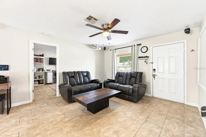 Inside, you’ll find a BRIGHT, OPEN-CONCEPT FLOOR PLAN featuring the Living Room, Dining area, and Kitchen flowing seamlessly together, all enhanced by BEAUTIFUL CERAMIC TILE FLOORING throughout the entire home—NO CARPET anywhere.
