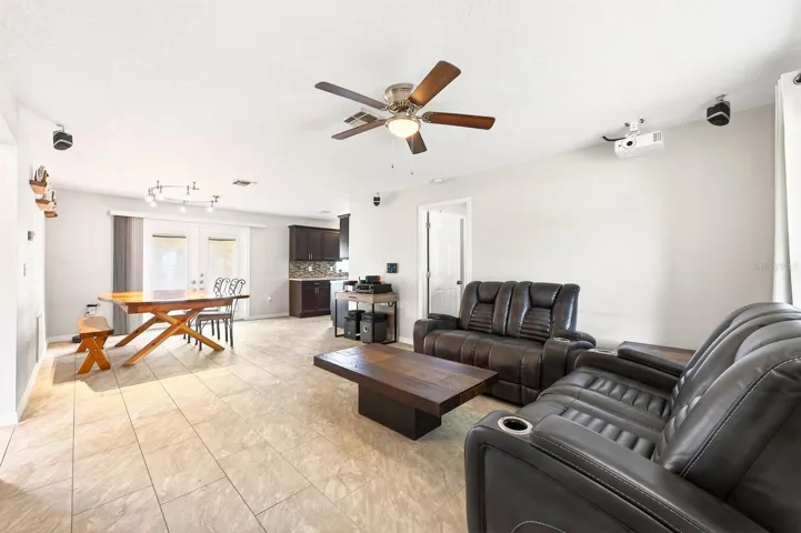 Inside, you’ll find a BRIGHT, OPEN-CONCEPT FLOOR PLAN featuring the Living Room, Dining area, and Kitchen flowing seamlessly together, all enhanced by BEAUTIFUL CERAMIC TILE FLOORING throughout the entire home—NO CARPET anywhere.