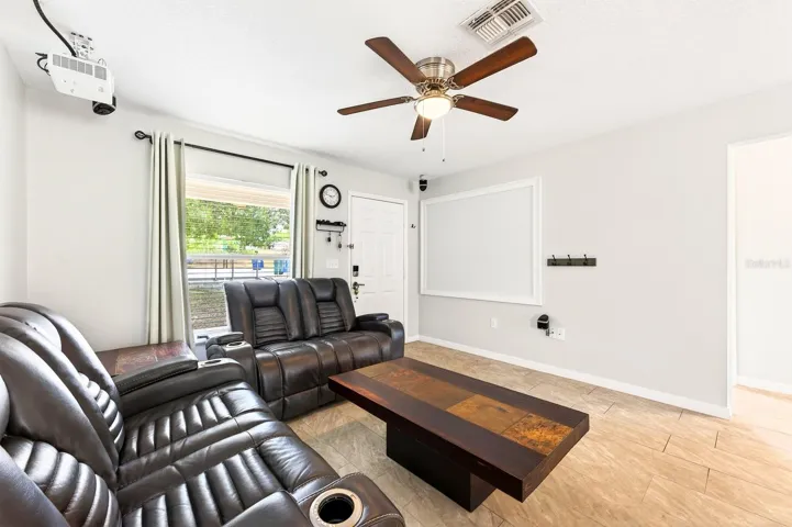With lots of NATURAL LIGHT, the Living Room is designed for entertaining and relaxing, complete with a PROJECTOR and HOME THEATER SYSTEM (2020), creating the perfect setting for movie nights or game-day gatherings.