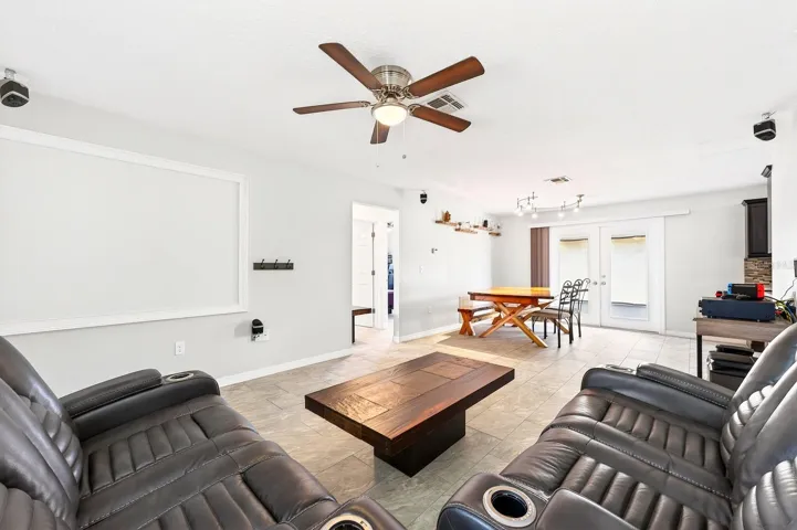 With lots of NATURAL LIGHT, the Living Room is designed for entertaining and relaxing, complete with a PROJECTOR and HOME THEATER SYSTEM (2020), creating the perfect setting for movie nights or game-day gatherings.
