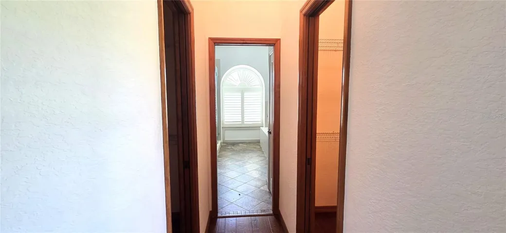 Hallway from Primary Bedroom to En-suite bath w/double closets on each side
