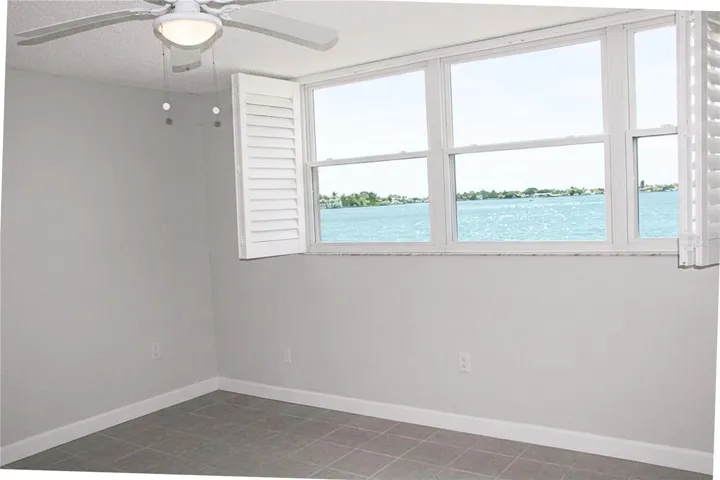 Virtually Staged With Plantation Blinds Beautiful Boca Ciega View From the Bedroom Window- Window Plantation Shutters Are Virtually Staged