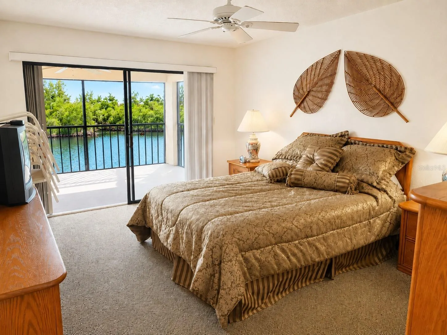Primary bedroom with lanai access via sliding glass doors.