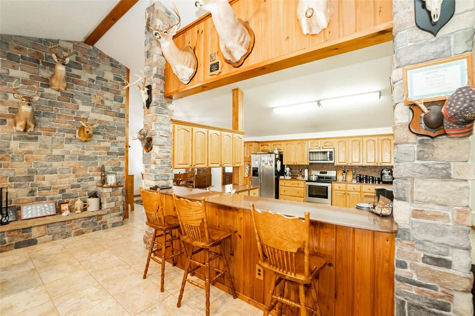 Commercial-style serving bar connecting kitchen and common areas